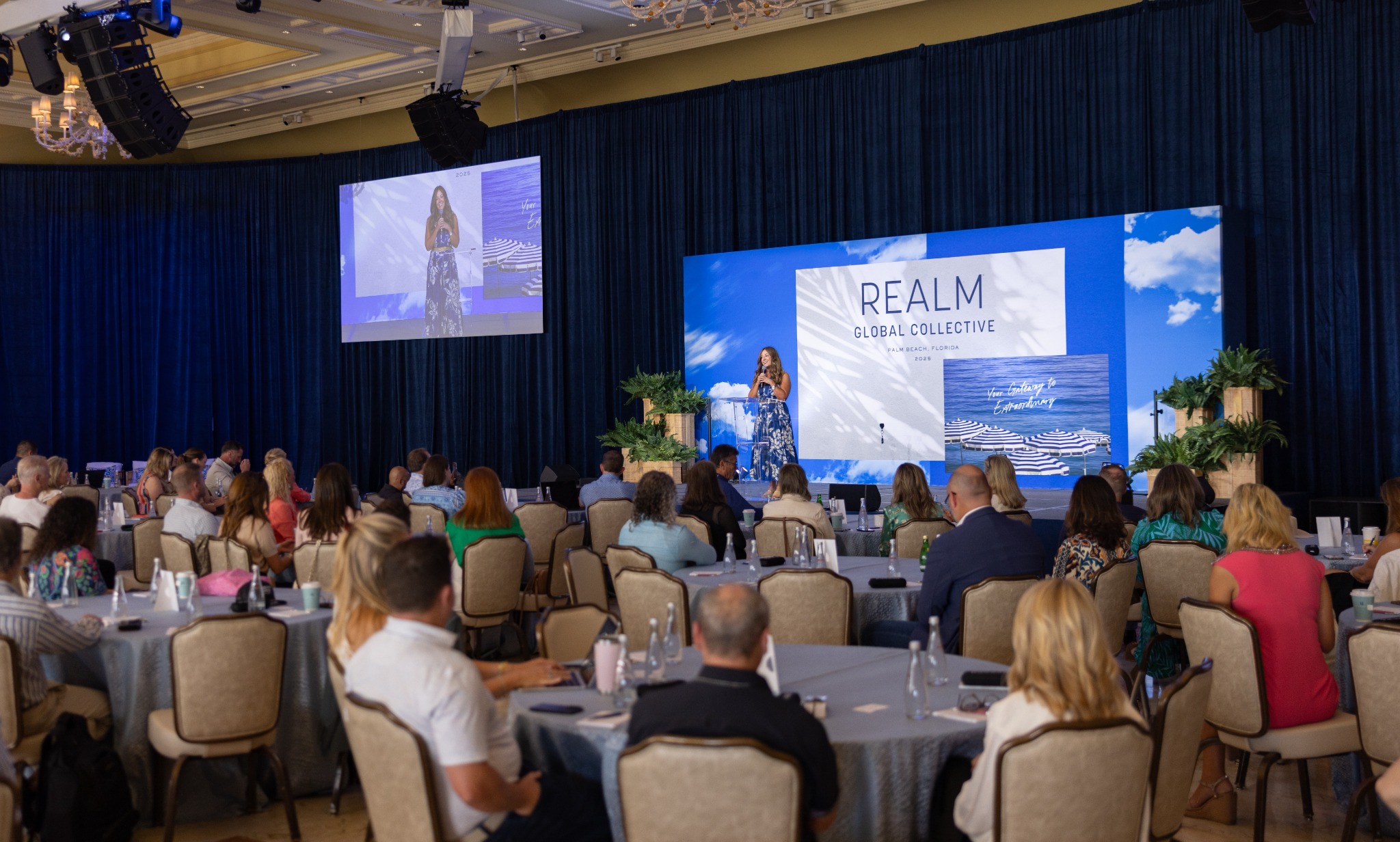 Corporate conference produced in a ballroom with stage, projection, lighting, and audience seating