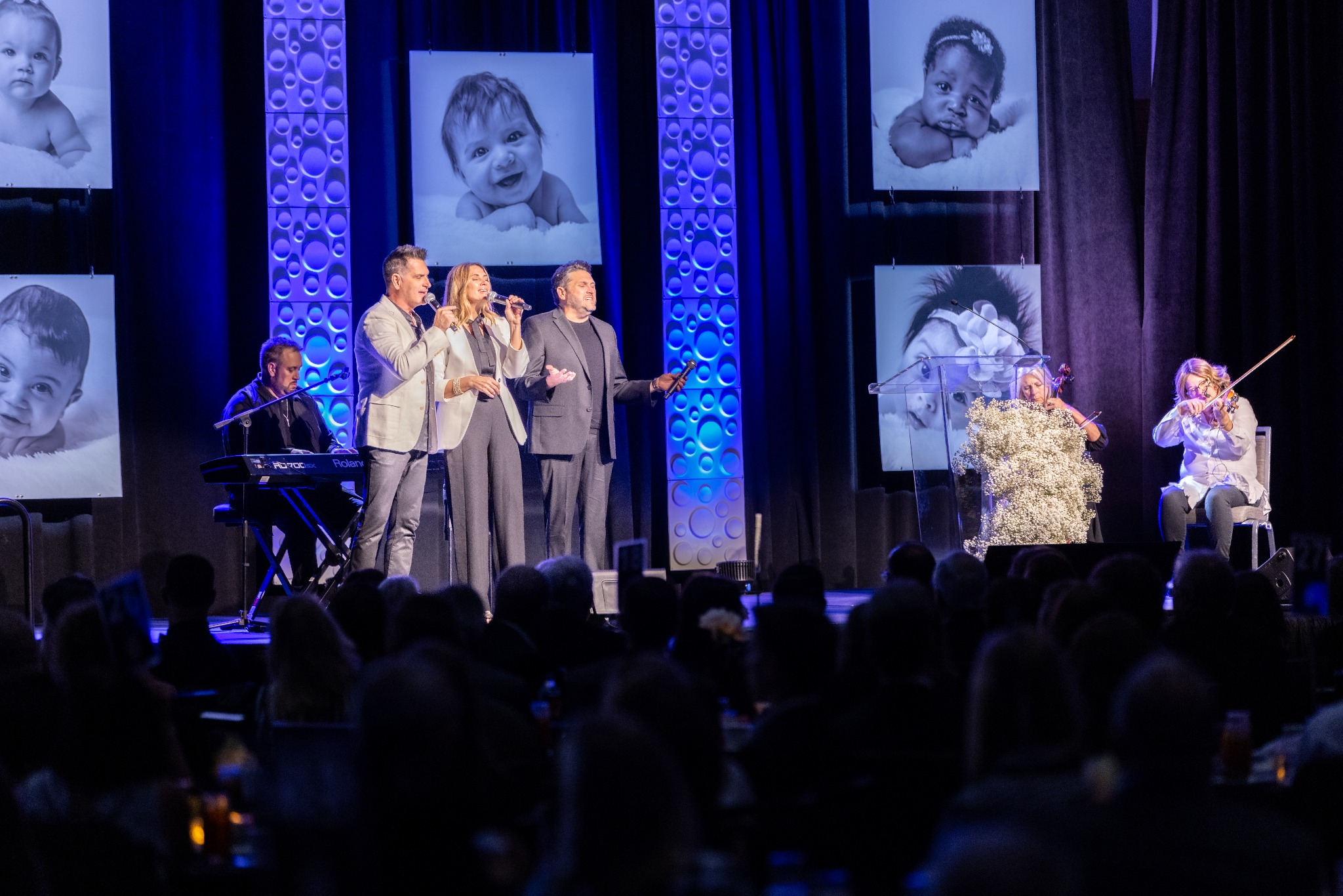 Live musical performance on a blue-lit gala stage