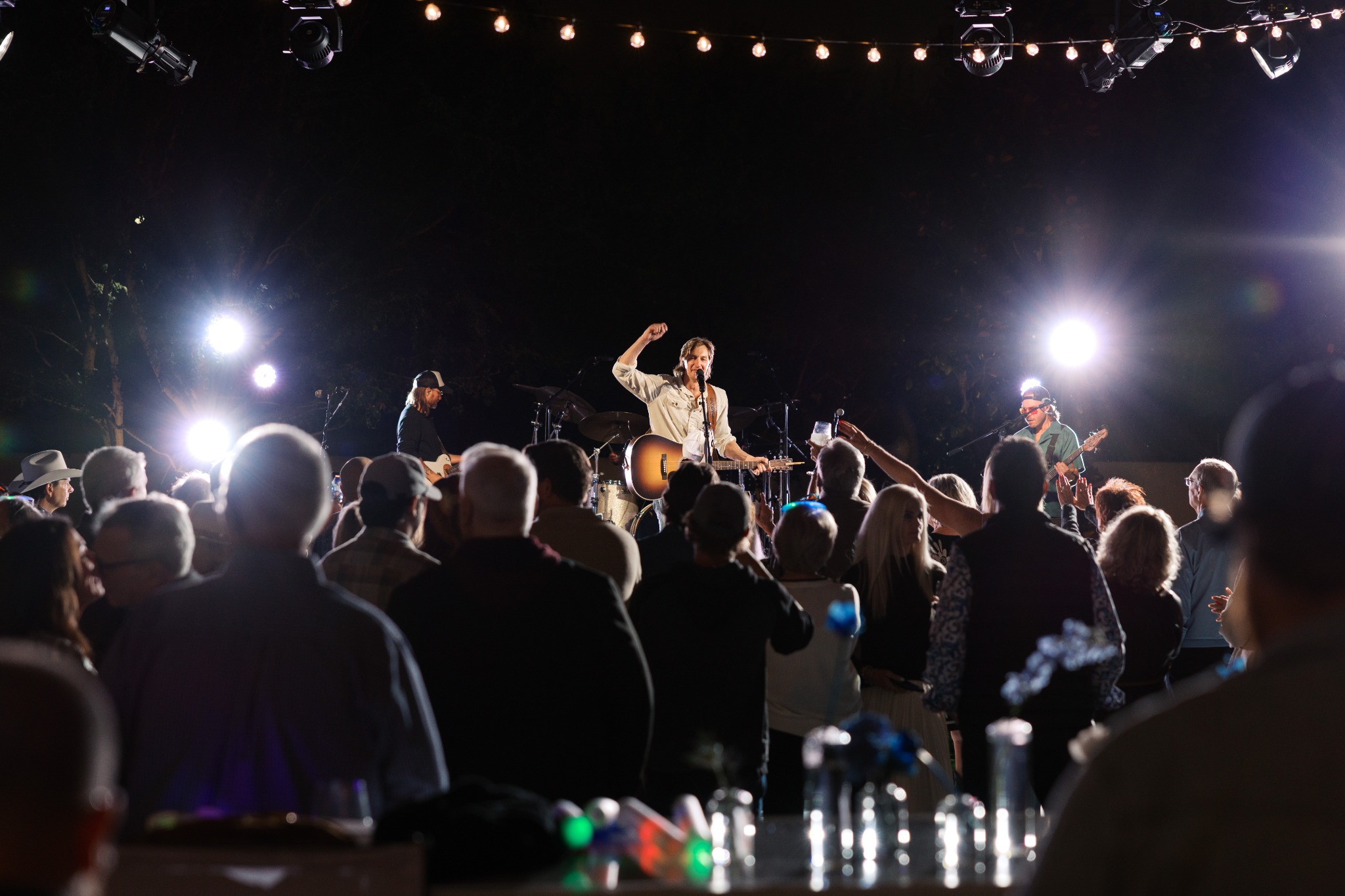 Live band performing for guests at a private outdoor celebration